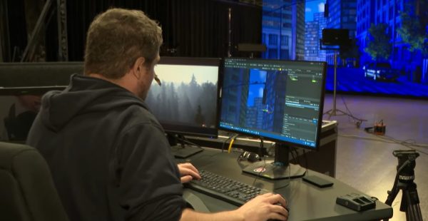 Virtual Production stage operator sits at a computer with Unreal Engine open