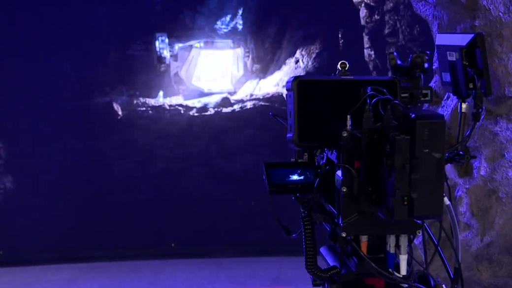 A camera facing a virtual production screen
