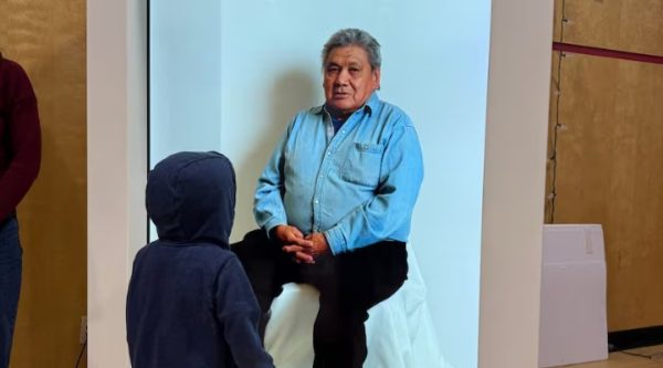 Walter Peter appears as a hologram, as a young child gazes up at him.