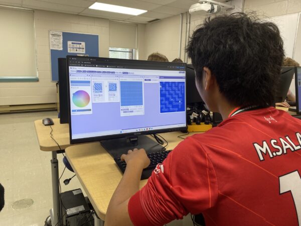 A teenager works on a Bitsy game in his web browser.
